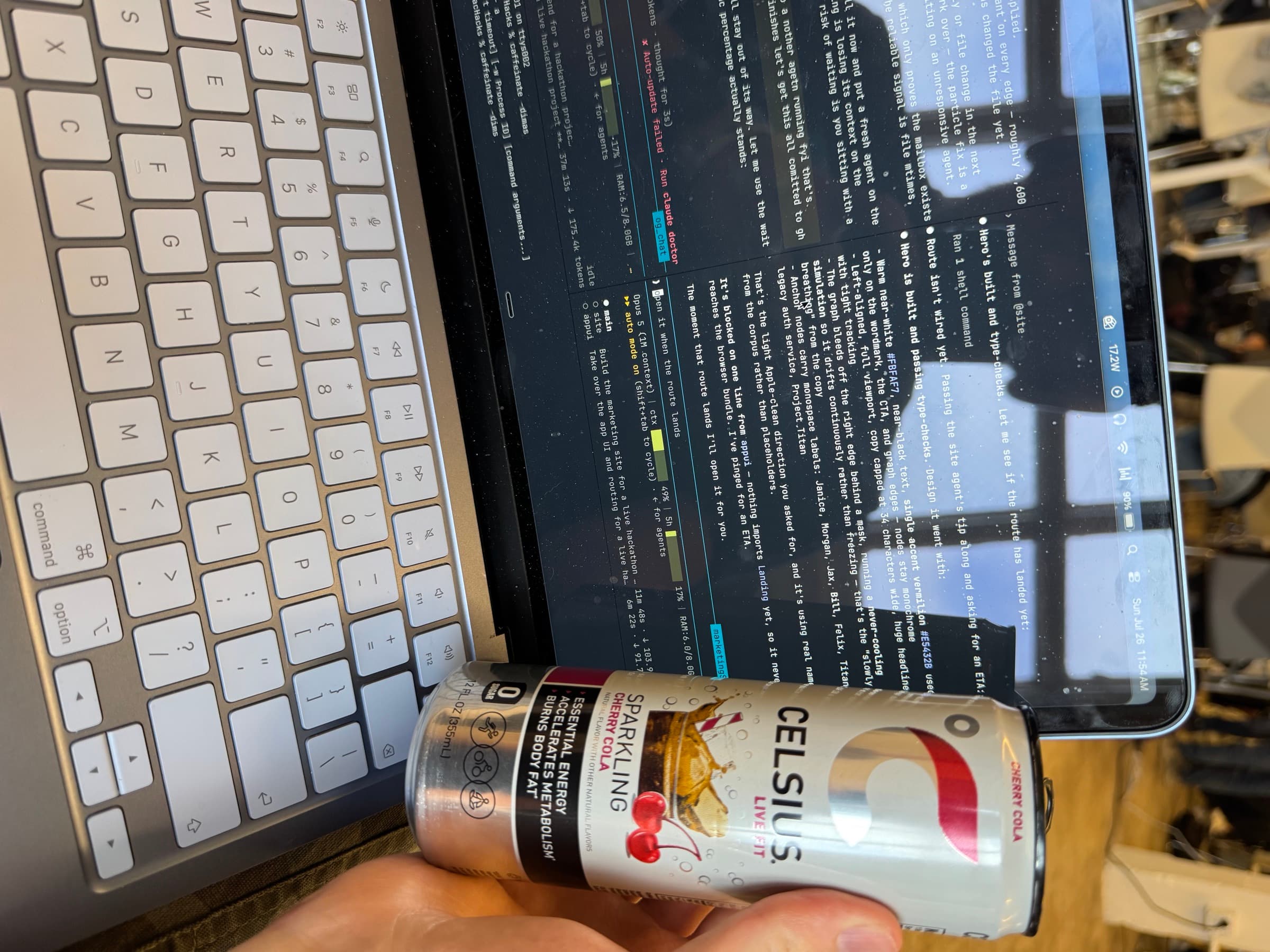 A can of Celsius resting on a laptop screen running an agent session in the terminal